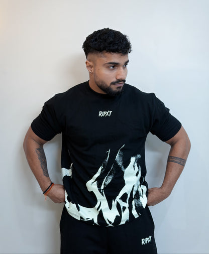 Person wearing a black t-shirt with white graphics and 'RIPX' branding against a plain background