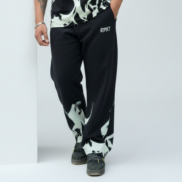 Person wearing black and white patterned pants with 'Ripkt' branding on a light gray background