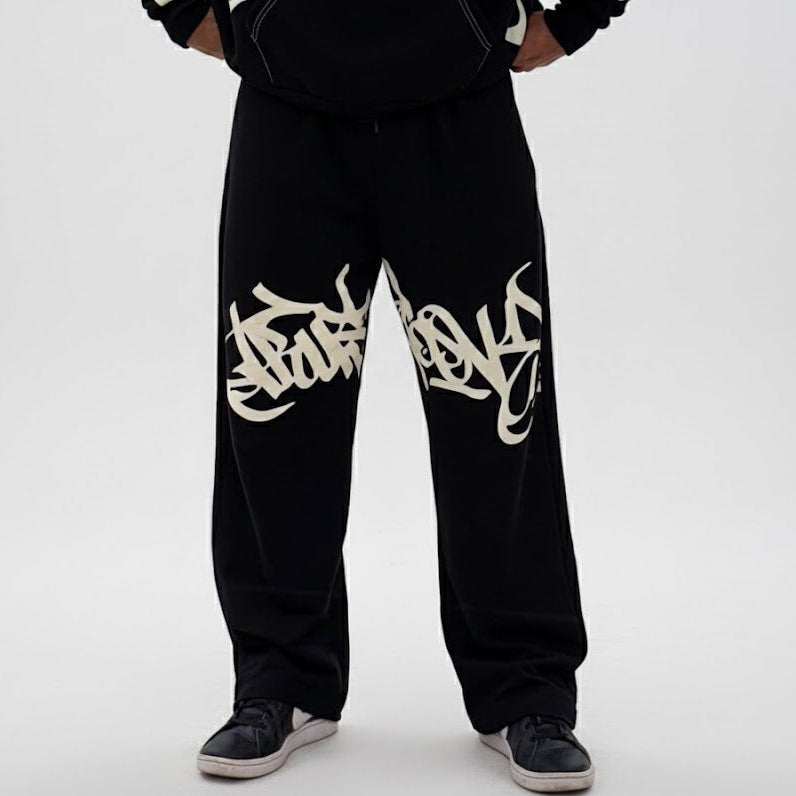 Black sweatpants with white text design on a white background